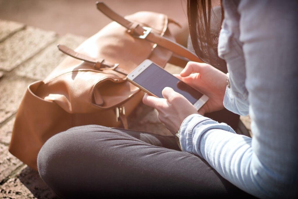 Woman using a smartphone to communicate with AI in customer service