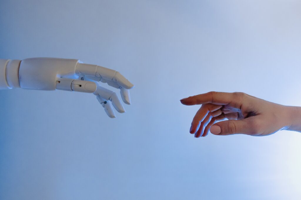 robot hand reaching out to human